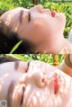 A woman laying in the grass with her eyes closed.