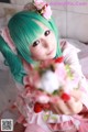 A woman with green hair holding a bouquet of flowers.