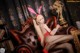 A woman in a bunny costume sitting on a couch.