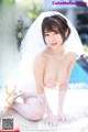 a japanese woman in a wedding dress is posing by the pool