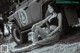 A woman sitting on the ground next to a jeep.