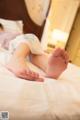 A woman laying on a bed with her feet up.