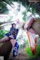 A couple of women sitting on top of a tree.